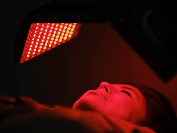 istock Woman On an LED Bed Receiving Red Light Therapy 2030963184