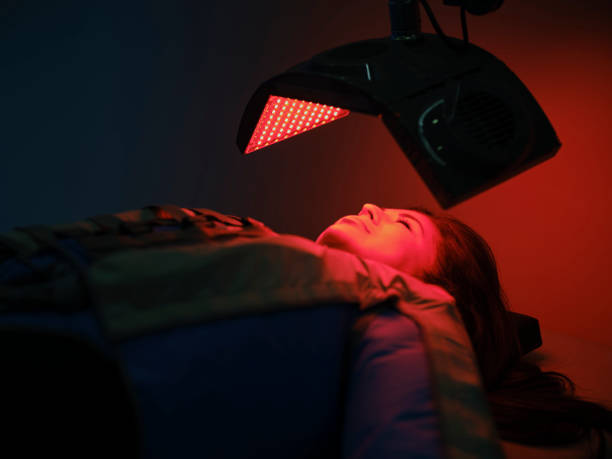 istock Woman On an LED Bed Receiving Red Light Therapy 2030963409