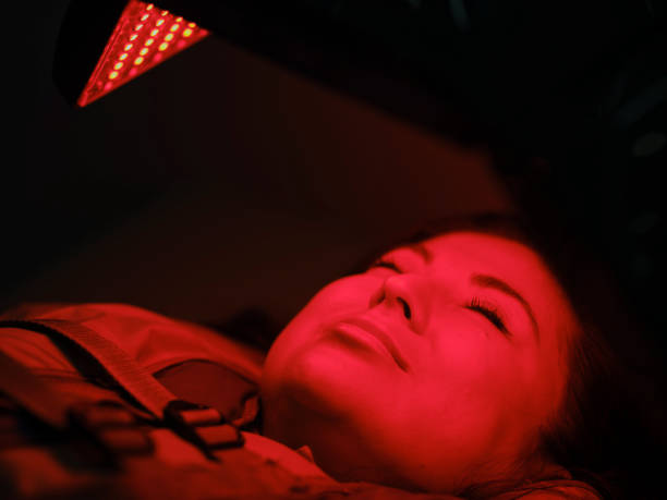 istock Woman On an LED Bed Receiving Red Light Therapy 2030963823