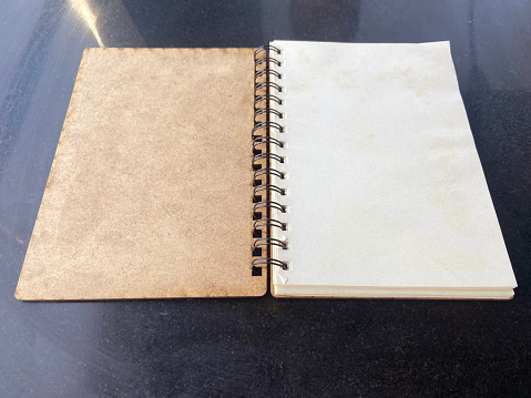 Open empty ring binder notebook on table with copy space