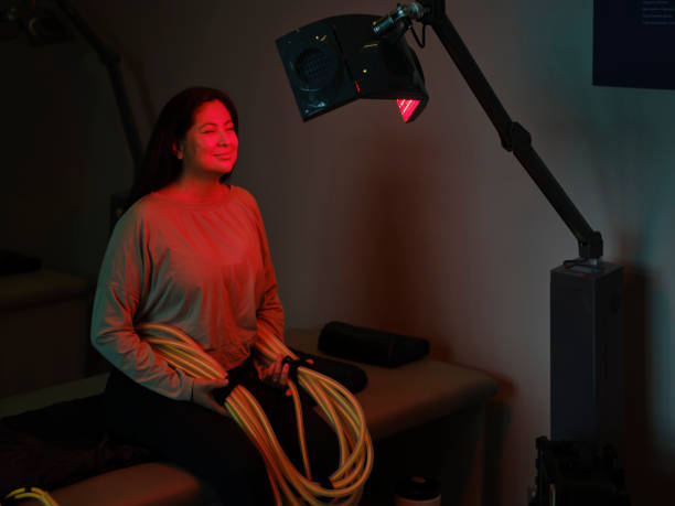 istock Woman On an LED Bed Receiving Red Light Therapy 2030969513