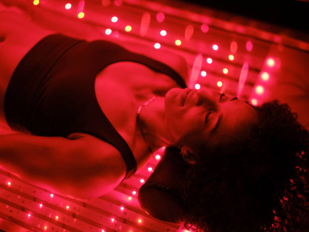 Woman On an LED Bed Receiving Red Light Therapy
