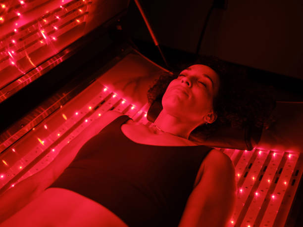 istock Woman On an LED Bed Receiving Red Light Therapy 2030972617