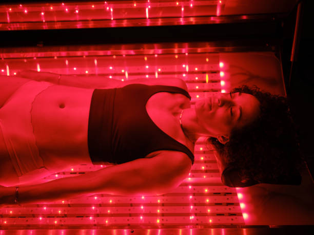 istock Woman On an LED Bed Receiving Red Light Therapy 2030974159