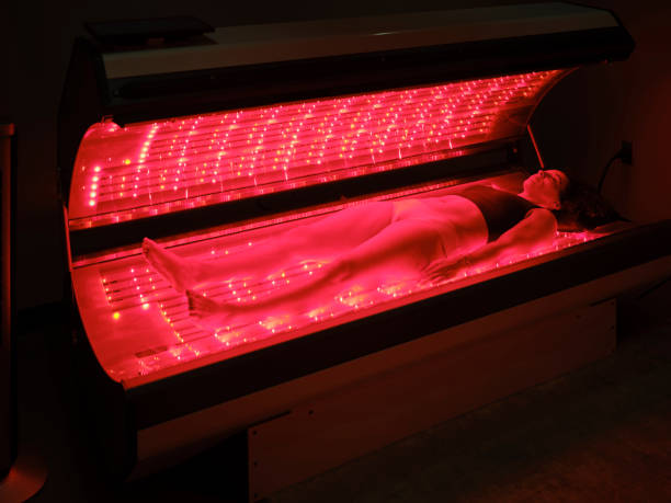 istock Woman On an LED Bed Receiving Red Light Therapy 2030974685