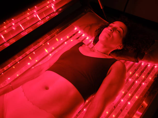 istock Woman On an LED Bed Receiving Red Light Therapy 2030975206