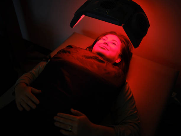 istock Woman On an LED Bed Receiving Red Light Therapy 2030976248