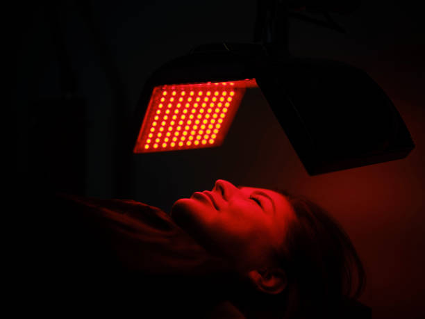 istock Woman On an LED Bed Receiving Red Light Therapy 2030977296