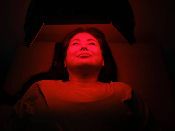 istock Woman On an LED Bed Receiving Red Light Therapy 2030977809
