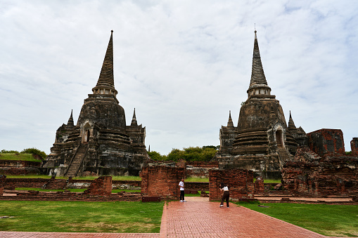 Ayutthaya, Thailand - August 26, 2023: tourists visiting the old Phra Si Sanphet temple complex.