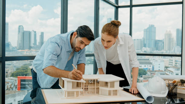istock Cooperative engineer team working together to measure house model. Tracery 2031034500