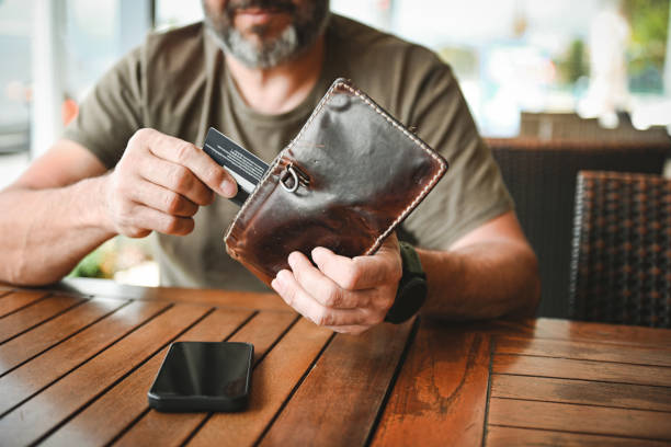 man paying with a credit card in a cafe