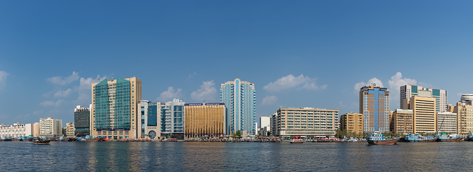 A picture of some buildings that side the Dubai Creek.
