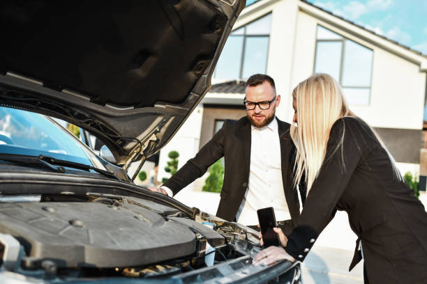 istock Business Couple Trying To Solve Car Heating Issue While Car Stops Due To Overheating On The Road 2031090410