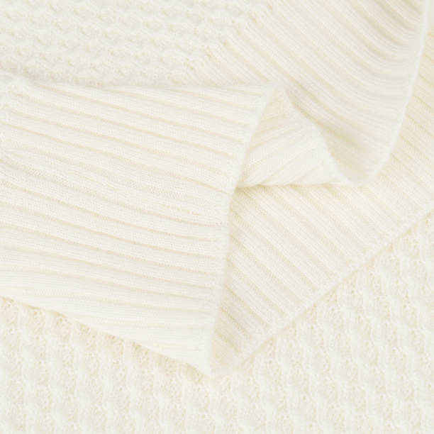 istock Knitted elastic band on creamy white wool sweater close up 2031122049