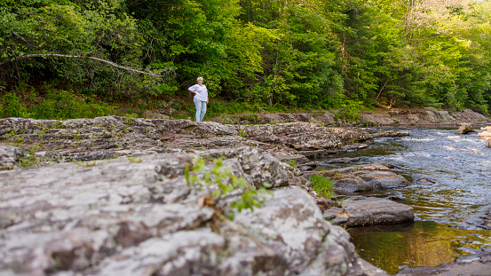 Nature exploration and summer walk by the mountain river in Pocono Mountain Region in Pennsylvania