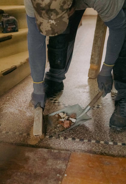 istock A young man holds a bag of construction waste indoors. 2031170255