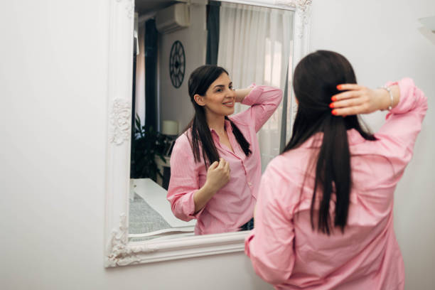 istock A beautiful woman looking at herself in the mirror. 2031174495