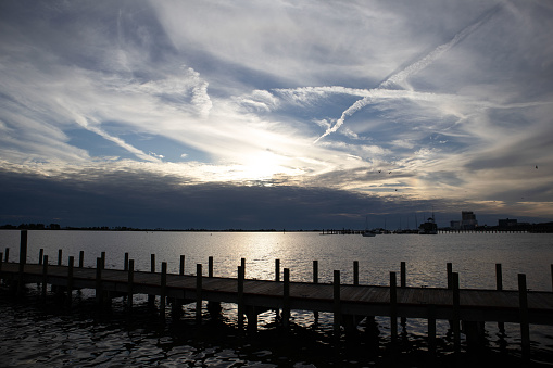 cloud derived chem trails blocking out a would-be beautiful sunset over the pier. Bioloxi, MS.