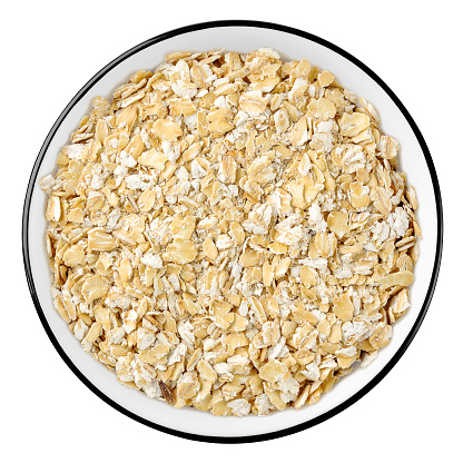 Top view of rolled oats in a bowl isolated on white background