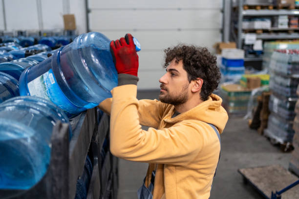 istock Man working at warehouse, carrying water bottles 2031269448