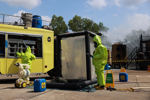 The Hazmat rescue team is preparing  and Checking All  Equipment on the hazmat truck to operate in the dangerous zone
