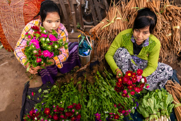 istock Burmese women selling flowers, Myanmar 2031305783