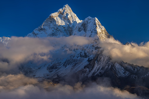 109 MPix XXXXL size panorama of Mount Ama Dablam - probably the most beautiful peak in Himalayas. 
 This panoramic landscape is an very high resolution multi-frame composite and is suitable for large scale printing
Ama Dablam is a mountain in the Himalaya range of eastern Nepal. The main peak is 6,812  metres, the lower western peak is 5,563 metres. Ama Dablam means  'Mother's neclace'; the long ridges on each side like the arms of a mother (ama) protecting  her child, and the hanging glacier thought of as the dablam, the traditional double-pendant  containing pictures of the gods, worn by Sherpa women. For several days, Ama Dablam dominates  the eastern sky for anyone trekking to Mount Everest basecamp