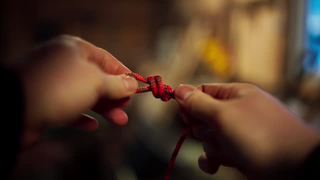 A Hand Tying a Knot - Close Up