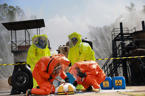 Emergency hazmat rescue  team giving first aid to a patient who suffered a chemical explosion