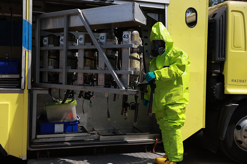 The Hazmat rescue team is preparing  and Checking All  Equipment on the hazmat truck to operate in the dangerous zone