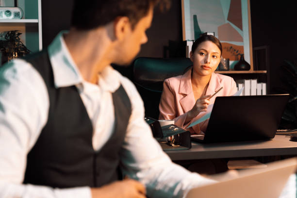 istock Focusing on woman presenting graph while man holding paper to sign. Postulate. 2031358430