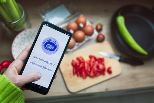 Using AI for culinary advice and cooking recipes. AI Chatbot in mobile application. Chatbot conversation, Ai Artificial Intelligence technology. Futuristic technology. Virtual assistant on internet. Using AI at everyday lives.