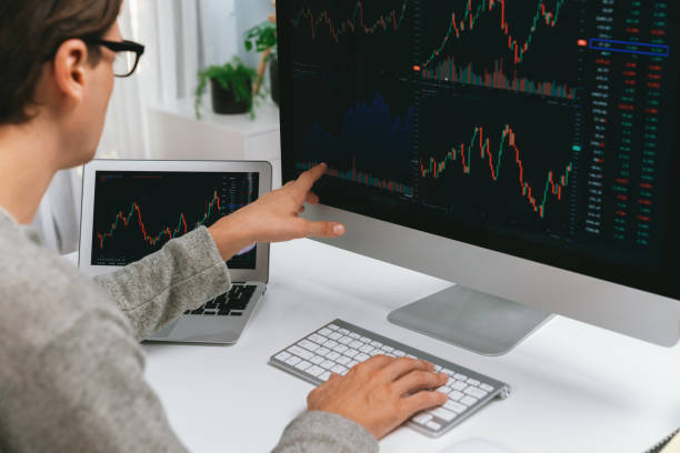 istock Investors pointing interesting stock exchange on pc with laptop. Pecuniary. 2031381106