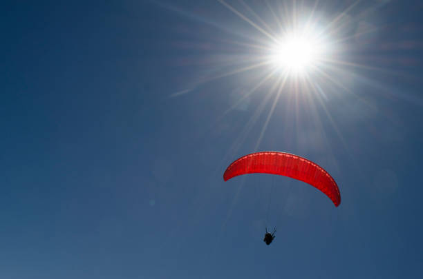 paraglider flying with mountain range landscape, concept fly, loneliness, tranquility