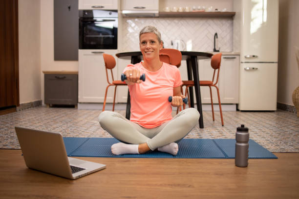 istock Woman at home keeping fit by exercising 2031416793