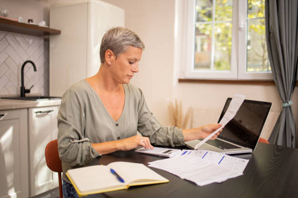 istock Mature woman going through paperwork 2031417319