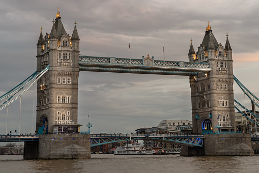 London, UK - Feb 15, 2024 - Scenery view of famous Tower bridge and skyline in the river thames at evening. Copy space, Selective focus.