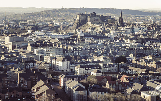 Edinburgh, Scotland - Jan 17, 2024 - Amazing Edinburgh Cityscape and Edinburgh Castle seen from the top of Salisbury Crags. Destinations in Europe, Copy space, Selective focus.