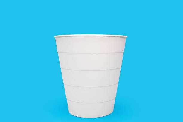 Disposable soda cup with drinking straw isolated on a white background.