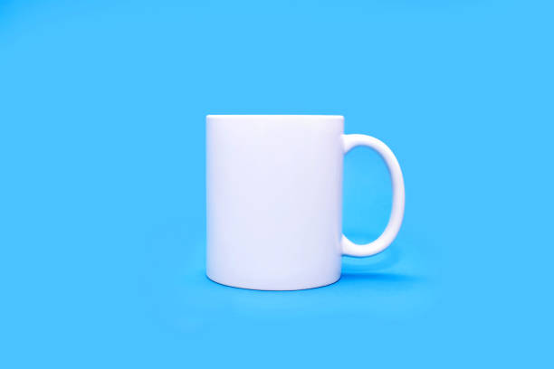 istock White mug on a blue background in the center 2031483172