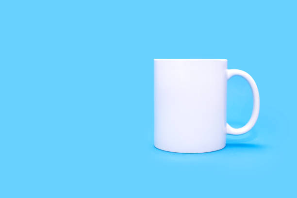 istock White mug on a blue background with free space for text 2031483682