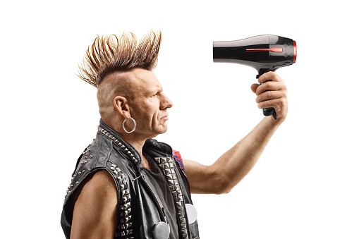 Punk with a mohawk using a hair dryer isolated on white background