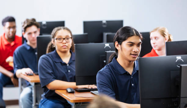 istock Multiracial teenage boy in high school computer class 2031589930