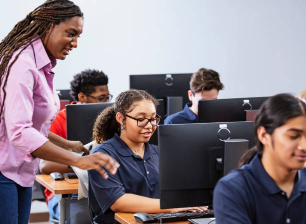 istock African-American high school teacher in computer lab 2031589963