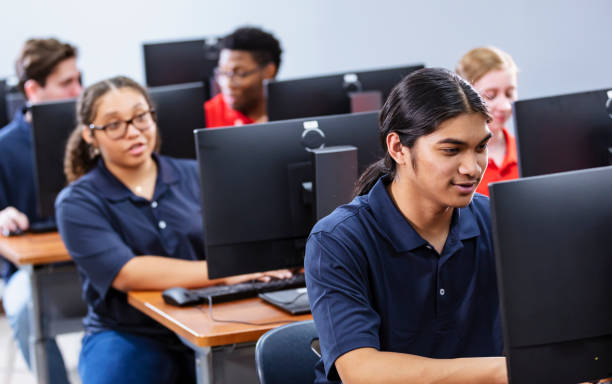 istock Multiracial teenage boy in high school computer class 2031589964
