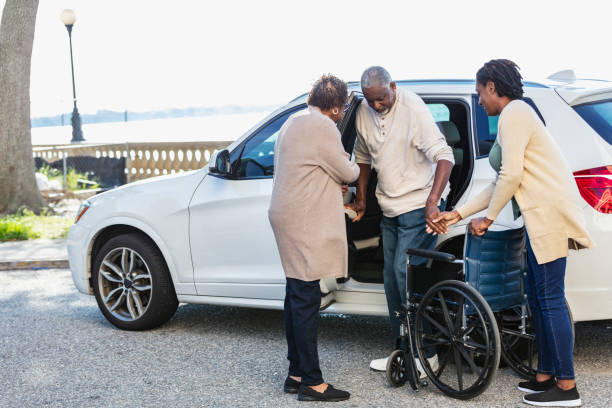 istock Senior man exiting car into wheelchair with help 2031591608