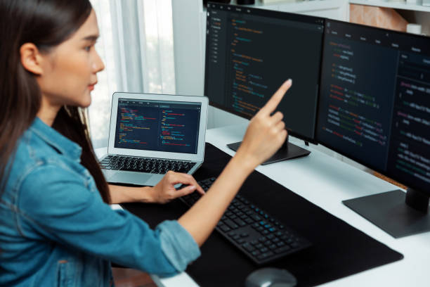 istock Young Asian in IT developer pointing online information on pc. Stratagem. 2031615407