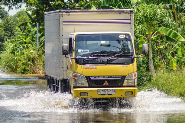 a logistics box truck passing through flood waters in Gresik district, Indonesia, 21 February 2024.