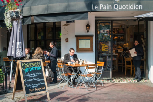 People sit on a patio of a cafe-restaurant in the Polanco neighborhood of Mexico City, Mexico in the morning.